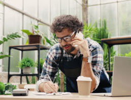 Man On Phone In Workshop