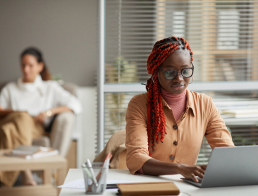 Woman Working At Laptop In Office