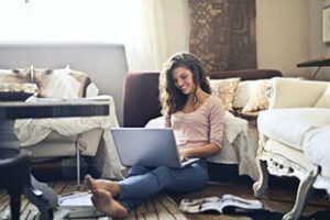 Woman Sitting On Floor Using Laptop 300x200